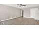 Bedroom with light wood flooring, ceiling fan, and white closet with shelving unit at 3345 Kilkenny Cir, Carmel, IN 46032