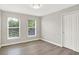 This bedroom is well-lit with wood flooring, two windows and a closet at 3345 Kilkenny Cir, Carmel, IN 46032