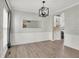 The dining room showcases wood floors, modern lighting, and seamless flow into the adjacent kitchen area at 3345 Kilkenny Cir, Carmel, IN 46032