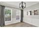 Stylish dining area features modern chandelier, large mirror, and natural light streaming through the windows at 3345 Kilkenny Cir, Carmel, IN 46032