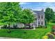 Inviting two-story home with lush landscaping, manicured lawn, and a classic brick facade at 3345 Kilkenny Cir, Carmel, IN 46032