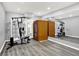 Basement gym features work-out equipment, a personal sauna, and mirrored wall at 3345 Kilkenny Cir, Carmel, IN 46032