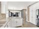 View from kitchen into open-concept living room with cozy fireplace at 3345 Kilkenny Cir, Carmel, IN 46032