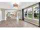 Open concept living area showcases wood floors, large windows, and views into the modern kitchen with white cabinetry at 3345 Kilkenny Cir, Carmel, IN 46032