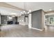 Open layout with wood floors, fireplace, and seamless flow between the living room, dining area, and kitchen at 3345 Kilkenny Cir, Carmel, IN 46032