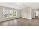 Bright living room features gleaming wood floors, large windows, and modern lighting fixture at 3345 Kilkenny Cir, Carmel, IN 46032