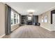 Bright living room featuring a fireplace, built-in shelving, large windows with natural light, and hardwood floors at 3345 Kilkenny Cir, Carmel, IN 46032