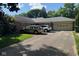 Well-maintained single-story brick home with an attached garage and a driveway, surrounded by lush greenery at 3440 W 46Th St, Indianapolis, IN 46228