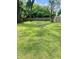 Expansive green backyard features a rustic stone fire pit perfect for outdoor gatherings at 3464 N Bancroft St, Indianapolis, IN 46218