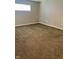 A bedroom featuring neutral walls, carpeted flooring, and a single window for natural light at 3464 N Bancroft St, Indianapolis, IN 46218
