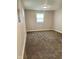 A bedroom featuring neutral walls, carpeted flooring, and a single window for natural light at 3464 N Bancroft St, Indianapolis, IN 46218