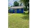 Charming blue single-story home featuring a well-manicured lawn and cozy front porch seating at 3464 N Bancroft St, Indianapolis, IN 46218