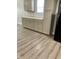 The kitchen features grey cabinets, light countertops, and wood-look flooring at 3464 N Bancroft St, Indianapolis, IN 46218