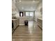 Open kitchen features grey cabinets, light countertops, and wood-look flooring at 3464 N Bancroft St, Indianapolis, IN 46218