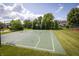 Community basketball court is set among mature trees with a park just beyond the fences at 3474 Glen Abbe Ct, Carmel, IN 46032