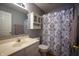 This bathroom offers decorative shower curtain and updated vanity at 3474 Glen Abbe Ct, Carmel, IN 46032
