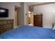 A bedroom showing the dark wood dresser and view to the bathroom and closet at 3474 Glen Abbe Ct, Carmel, IN 46032