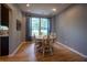 Dining room with a wooden table, chairs, hardwood flooring and large windows at 3474 Glen Abbe Ct, Carmel, IN 46032