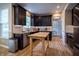 Modern kitchen with dark cabinets, stainless steel appliances, and center island at 3474 Glen Abbe Ct, Carmel, IN 46032