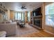Inviting living room featuring a cozy fireplace, large sectional sofa, and natural light from bay windows at 3474 Glen Abbe Ct, Carmel, IN 46032