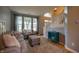 Cozy living room with comfortable seating, large windows, and a staircase at 3474 Glen Abbe Ct, Carmel, IN 46032