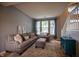Comfortable living room with a sofa, accent chair, area rug and staircase at 3474 Glen Abbe Ct, Carmel, IN 46032