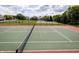 Well-maintained tennis court is ready for a match within a parklike setting at 3474 Glen Abbe Ct, Carmel, IN 46032