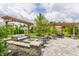 Charming backyard featuring a cozy patio with a pergola, swing, and fire pit area for outdoor relaxation at 3606 Evergreen Way, Zionsville, IN 46077