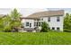 Backyard featuring a cozy patio with a pergola, swing, fire pit, and a well-maintained lawn at 3606 Evergreen Way, Zionsville, IN 46077