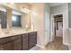 Elegant bathroom featuring double vanity, a mirror, and a walk-in closet at 3606 Evergreen Way, Zionsville, IN 46077