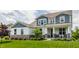 Inviting two-story home featuring professional landscaping and a covered front porch at 3606 Evergreen Way, Zionsville, IN 46077