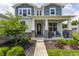 Inviting covered porch with lovely flowers and comfortable seating at 3606 Evergreen Way, Zionsville, IN 46077