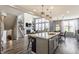 Open-concept kitchen flows into the dining and living areas, featuring a large island and modern finishes at 3606 Evergreen Way, Zionsville, IN 46077