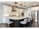 Well-lit kitchen with a spacious island, granite countertops, and stainless steel appliances, designed for culinary enthusiasts at 3606 Evergreen Way, Zionsville, IN 46077