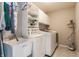 Bright laundry room with a sink, cabinets, and modern appliances at 3606 Evergreen Way, Zionsville, IN 46077