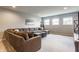 Comfortable living room featuring plush sofa, neutral carpet, and recessed lighting at 3606 Evergreen Way, Zionsville, IN 46077