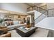 Spacious living room showcasing an open-concept design with a staircase and modern decor, blending comfort and style at 3606 Evergreen Way, Zionsville, IN 46077