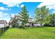 Spacious fenced backyard featuring mature trees and an outdoor dining area at 3740 Weather Stone Xing, Zionsville, IN 46077