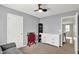 Bedroom with gray walls, carpet flooring, white dresser and view into hall at 3740 Weather Stone Xing, Zionsville, IN 46077