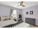Bright bedroom with ceiling fan, carpet, and a view to the window at 3740 Weather Stone Xing, Zionsville, IN 46077