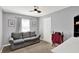 Bedroom featuring a gray sofa, ceiling fan, and natural light from a window at 3740 Weather Stone Xing, Zionsville, IN 46077