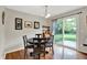 Dining room with hardwood floors and sliding doors providing backyard views at 3740 Weather Stone Xing, Zionsville, IN 46077