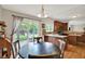 Bright dining area features a sliding door to the backyard, hardwood floors, and modern lighting at 3740 Weather Stone Xing, Zionsville, IN 46077