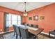 Dining room with rustic table, seating for eight, a decorative rug, and window views at 3740 Weather Stone Xing, Zionsville, IN 46077