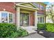Close up of the front door entrance, featuring a covered porch and manicured landscaping at 3740 Weather Stone Xing, Zionsville, IN 46077