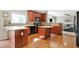 A well-lit kitchen with wooden cabinets, stainless steel appliances, tiled backsplash, and hardwood floors at 3740 Weather Stone Xing, Zionsville, IN 46077