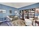 Comfortable living room with sofa, armchair, bookshelves, and a decorative rug at 3740 Weather Stone Xing, Zionsville, IN 46077