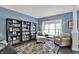 Cozy living room featuring built-in bookshelves, armchairs, and a decorative rug at 3740 Weather Stone Xing, Zionsville, IN 46077