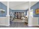 Bright living room with hardwood floors, decorative columns, and comfortable seating at 3740 Weather Stone Xing, Zionsville, IN 46077