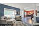 Inviting living room with large windows, armchairs, and view into the dining room at 3740 Weather Stone Xing, Zionsville, IN 46077
